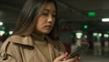 Serious Asian woman chinese korean japanese woman girl ethnic lady client customer driver in underground car parking Royalty Free Stock Photo