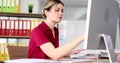 Serious attentively business woman working with documents and computer in fose