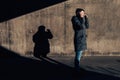 Serious authentic woman talking on mobile phone on the street Royalty Free Stock Photo