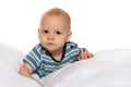 Serious baby boy in the bed Royalty Free Stock Photo