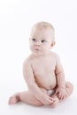 Serious baby-boy in a diaper sitting on the floor Royalty Free Stock Photo