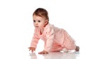 Serious baby girl creeping forward looking ahead Royalty Free Stock Photo