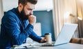 Serious bearded businessman working on computer, drinking coffee, thinking. Man analyzes information, checking email. Royalty Free Stock Photo