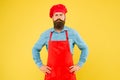 Serious bearded chef. brutal male cook in hat and apron. professional man cooking. restaurant cuisine and culinary Royalty Free Stock Photo