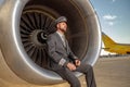 Aircraft pilot sitting in airplane engine at airport