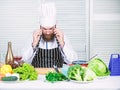 Serious bearded man. chef recipe. Dieting organic food. Vegetarian salad with fresh vegetables. Healthy food cooking