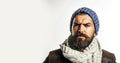 Serious bearded man in fashionable clothing. Handsome male model in stylish leather jacket, colorful hat wrapped in Royalty Free Stock Photo