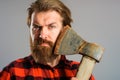 Serious bearded man with old axe. Canadian lumberjack with ax near face. Closeup portrait. Royalty Free Stock Photo