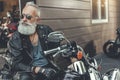 Serious bearded old man on motorbike Royalty Free Stock Photo