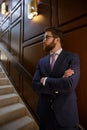 Serious bearded young businessman standing with arms crossed Royalty Free Stock Photo
