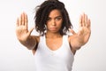 Serious black girl showing stop sign with two hands