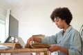 Serious blackwoman folding garment for dispatch