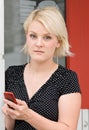 Serious Blond with Phone Royalty Free Stock Photo