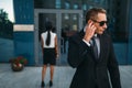 Serious bodyguard in suit and sunglasses, guarding