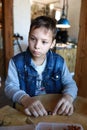 Serious boy making bracelet at workshop Royalty Free Stock Photo