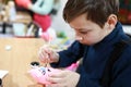 Serious boy painting stuffed toy Royalty Free Stock Photo