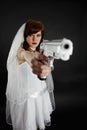 Serious bride take aim with a pistol