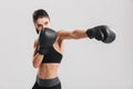 Serious brunette fitness woman training in boxing gloves while l Royalty Free Stock Photo