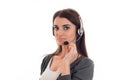 Serious brunette woman working in call center with headphones and microphone looking at the camera isolated on white Royalty Free Stock Photo