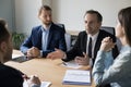 Serious business man in formal suit talking to partners Royalty Free Stock Photo