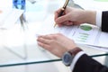 Serious business man working on documents looking concentrated with briefcase and phone on table Royalty Free Stock Photo