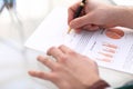 Serious business man working on documents looking concentrated with briefcase and phone on table Royalty Free Stock Photo