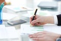 Serious business man working on documents looking concentrated with briefcase and phone on table Royalty Free Stock Photo