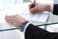 Serious business man working on documents looking concentrated with briefcase and phone on table Royalty Free Stock Photo