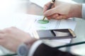 Serious business man working on documents looking concentrated with briefcase and phone on table Royalty Free Stock Photo