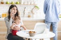 Serious business mom talking on phone, working from home with baby Royalty Free Stock Photo