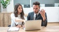 Serious business woman and man discussing project on laptop in office. Royalty Free Stock Photo