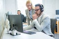 Serious business woman and man looking at the computer screen together in the office. Royalty Free Stock Photo