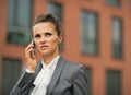 Serious business woman talking cell phone Royalty Free Stock Photo