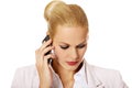 Serious business woman talking through a mobile phone Royalty Free Stock Photo