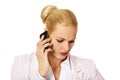 Serious business woman talking through a mobile phone Royalty Free Stock Photo