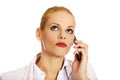 Serious business woman talking through a mobile phone Royalty Free Stock Photo
