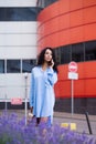 A serious business woman is talking on a smartphone near an office building Royalty Free Stock Photo