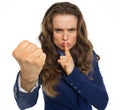 Serious business woman threatening with fist