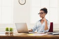 Serious business woman working on laptop at office Royalty Free Stock Photo