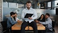 Serious businessman boss leader man sit on desk table in office check paperwork pensive write with folder business Royalty Free Stock Photo