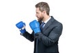 Serious businessman in formal suit and boxing gloves in fighting position isolated on white, fight Royalty Free Stock Photo