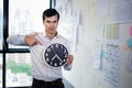 Serious businessman holding big clock in his hands, Time to work Royalty Free Stock Photo