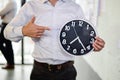 Serious businessman holding big clock in his hands, Time to work Royalty Free Stock Photo