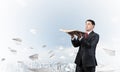 Serious businessman holding open old book