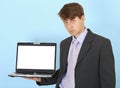 Serious businessman holds on hand laptop Royalty Free Stock Photo