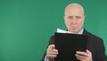 Serious Businessman Image Reading Documents With Green Screen Background Royalty Free Stock Photo