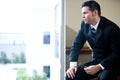 Serious businessman looking out office window Royalty Free Stock Photo