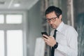 Serious businessman reading text message on smart phone Royalty Free Stock Photo