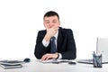 Serious businessman skeptically looking at you sitting at his desk isolated on white background.Human face expression