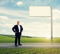 Serious businessman standing on the road Royalty Free Stock Photo